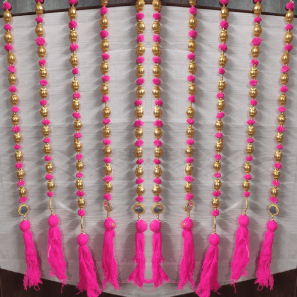 Multi color Pom-poms Handmade strings with golden gotta ball, mirror & tassels Hanging strings/garlands/torans/wall hangings are best choice for decoration ( 3 Feet) Made in India. Beautiful wall hanging Toran for home decoration. It can be used to decorate pooja room, home entrance door, can be hung like Toran in any design. It can be used for decoration of hall, living room or drawing room, balcony and garden also. A beautiful home decor for any function, pooja, marriage ceremony, engagement, or festivals such as diwali, dusshera, Ganesh Chaturthi Wedding Theme Party Props etc. The wall hanging torans are long lasting and can be easily washed and reused. You can hang it anywhere on your doorway, main door, railings, on the sides of mirror etc. It adds the touch of Tradition to the interiors of your house. Length of the strings is 3 Feet.