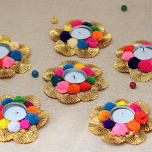 Each tealight holder is meticulously handcrafted by skilled artisans, using recycled materials to create a stunning flower design that adds a unique touch to your decor. Vibrant Multicolour: The multicolour design brings a splash of brightness and cheerfulness to any room, perfect for enhancing the ambiance during festivals, special occasions, or everyday use. Generous Dimensions: At 24 x 36 cm, these holders are large enough to make a bold statement while providing ample space for tealight candles, making them ideal for tables, shelves, and mantels. Eco-Friendly Craftsmanship: Made from recycled materials, these holders reflect a commitment to sustainability and environmental responsibility without compromising on style or durability. Pack of 6 Holders: This pack includes six beautifully crafted tealight holders, offering versatility for decorating various spaces or for gifting to loved ones.