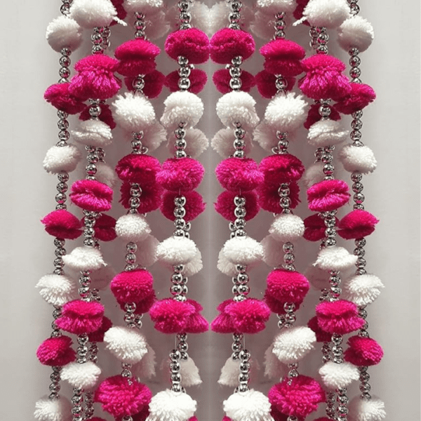 Decorate your home/doors and bring good luck to your home by these Pom Pom Flowers Garlands Torans. Pom Pom can be hanged on doors and can be used on many occasions like Corporate Gifts, Diwali Decorations , Pooja ghar, Festivals, House Warming, Wedding, Parties and inaugurations. Material: Handmade product made up of woolen pom-pom,golden beads, Chakri and golden decorative hanging bells Can be used to create strings. The wall hanging torans are long lasting and can be easily washed and reused. Can be used to create strings' curtains in living area. Looks good as wall hangings, door torans, window backdrops etc.